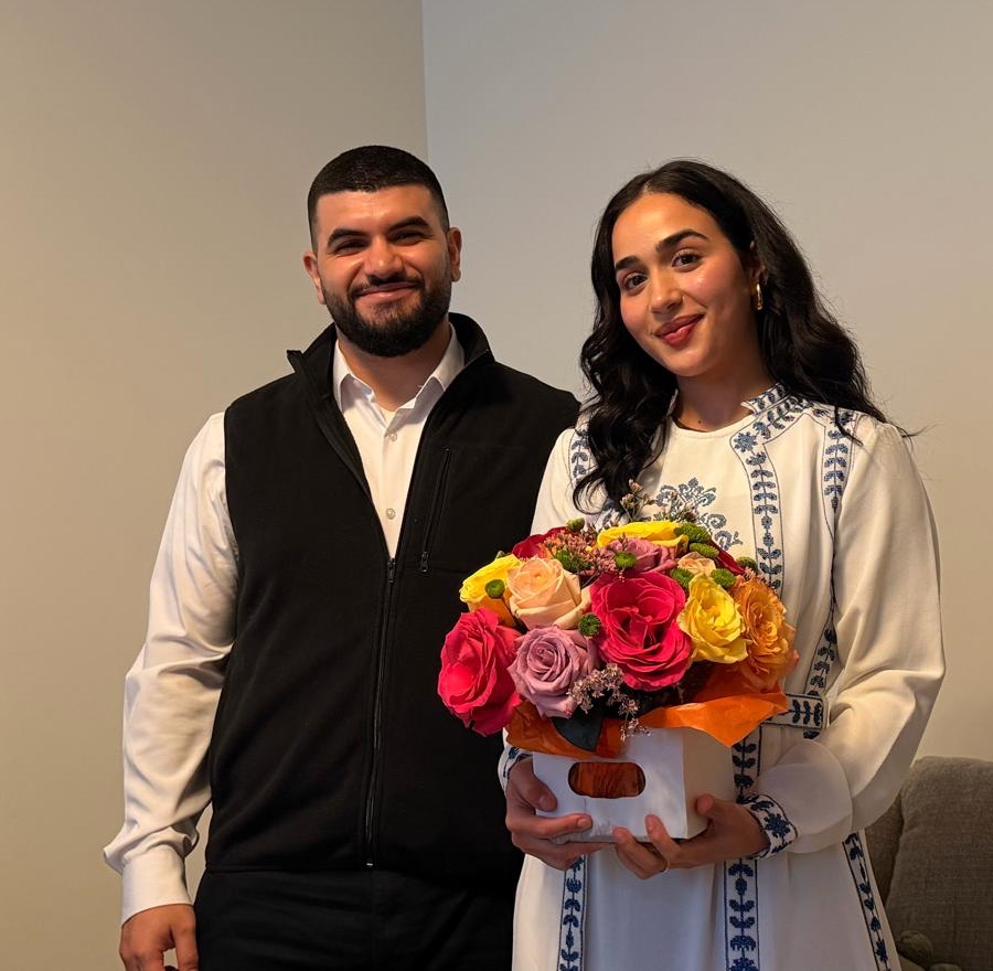 Kamal and Hanin standing together, Hanin holding a box of roses